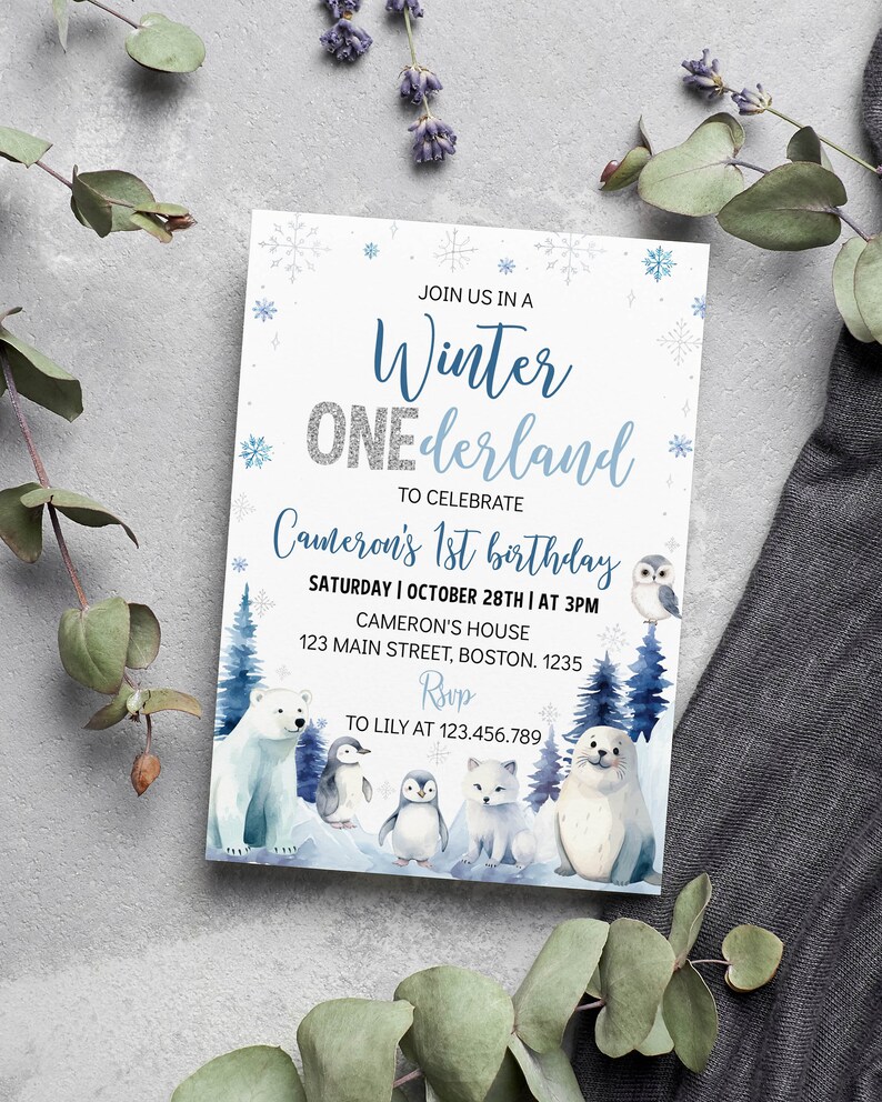May include: A rectangular invitation card featuring a winter theme with blue and silver text reading Winter ONEderland to celebrate Cameron's 1st birthday. The design includes watercolor illustrations of a polar bear, penguins, a fox, and a seal.