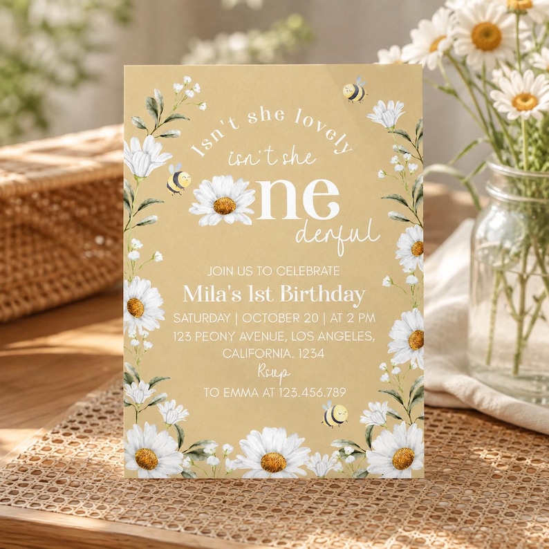 May include: A rectangular birthday invitation card on a tan background featuring white daisy illustrations, green leaves, and small yellow bees. The text reads: Isn't she lovely isn't she one derful, Join us to celebrate Mila's 1st Birthday, October 20.