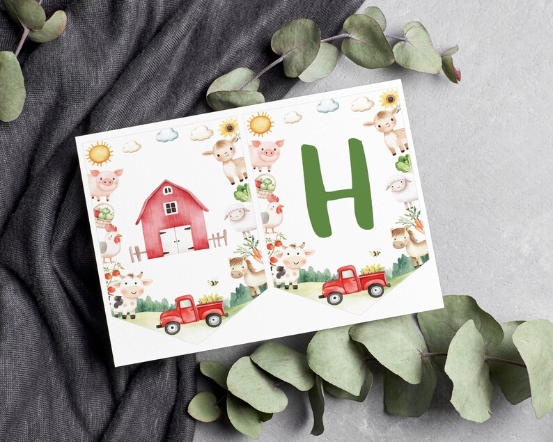 May include: Two white pennant flags featuring watercolour farm illustrations. One flag displays a red barn, a red truck, and various farm animals including a pig, sheep, cow, and horse. The other flag features a large green letter H and a red truck.