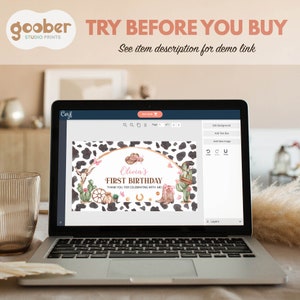 May include: A laptop screen displaying a digital birthday invitation template with a cow print background. The design features watercolor illustrations of a cowboy hat, cactus, wagon wheel, and boots with the text Olivia's FIRST BIRTHDAY.