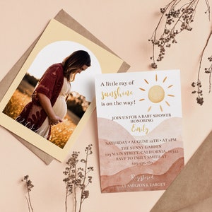 May include: A baby shower invitation with a watercolour background in shades of brown and orange. The invitation features a sun graphic and the text "A little ray of sunshine is on the way!"  Join us for a baby shower honouring Emily. Saturday, August 12th at 2 pm. The Sunny Garden, 123 Main Street, California, 19345. RSVP to Emily Smith at 123-456-7890. Registered at Amazon & Target.