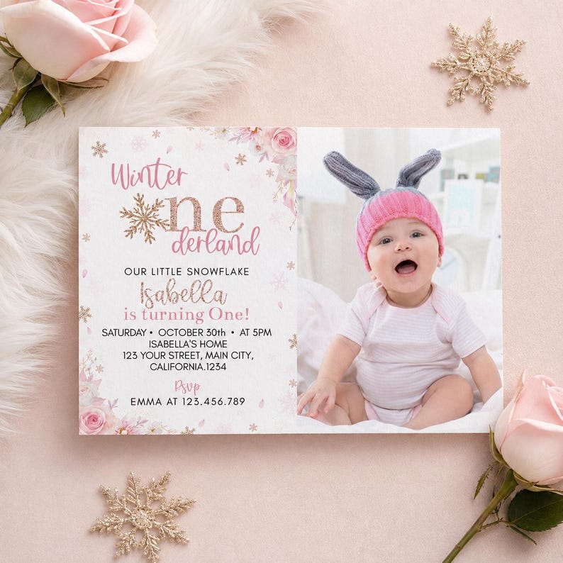 May include: A rectangular birthday invitation card featuring pink floral accents, gold snowflakes, and the text Winter onederland. The card includes details for Isabella's first birthday on October 30th at 5PM, and a photo of a baby in a pink hat.