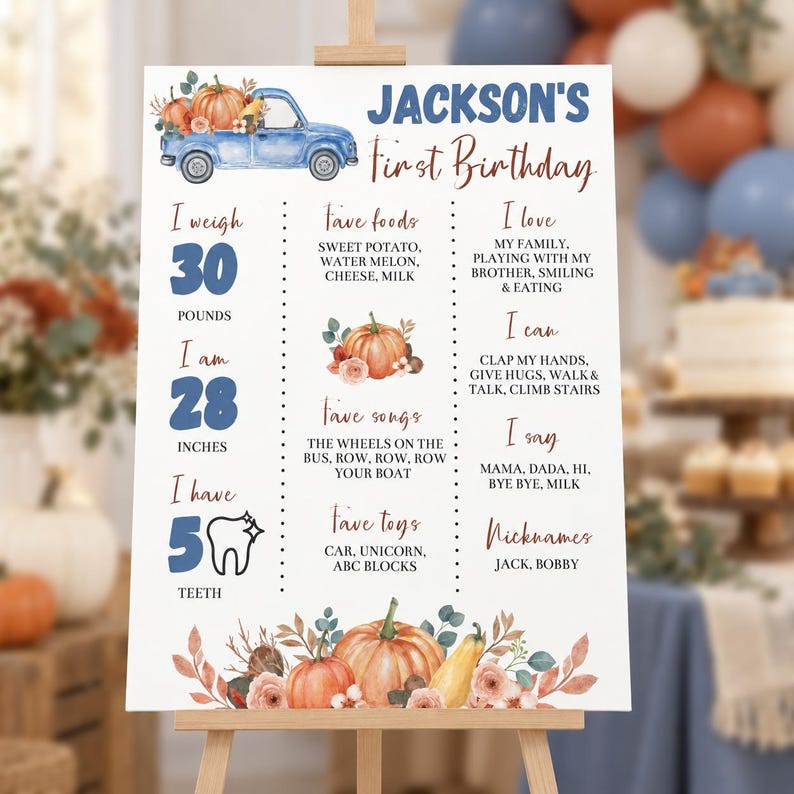 May include: A white birthday milestone sign for Jackson featuring a blue watercolor truck, pumpkins, and floral accents. The text includes details like 30 pounds, 28 inches, 5 teeth, favorite foods, songs, toys, and personal milestones in blue and brown.