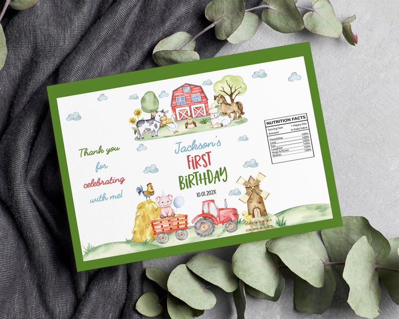 May include: A rectangular card with a green border featuring watercolor farm illustrations including a red barn, tractor, windmill, and animals. Text reads Jackson's FIRST BIRTHDAY 10.01.202X, Thank you for celebrating with me, and a Nutrition Facts label.