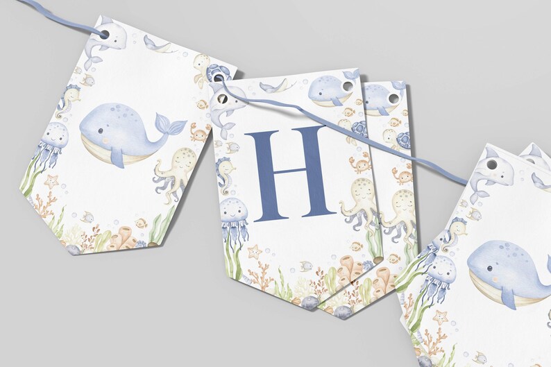 May include: A nautical-themed banner with a light blue ribbon. The banner features watercolor illustrations of whales, jellyfish, octopuses, and other sea creatures. One banner displays the letter "H" in blue.