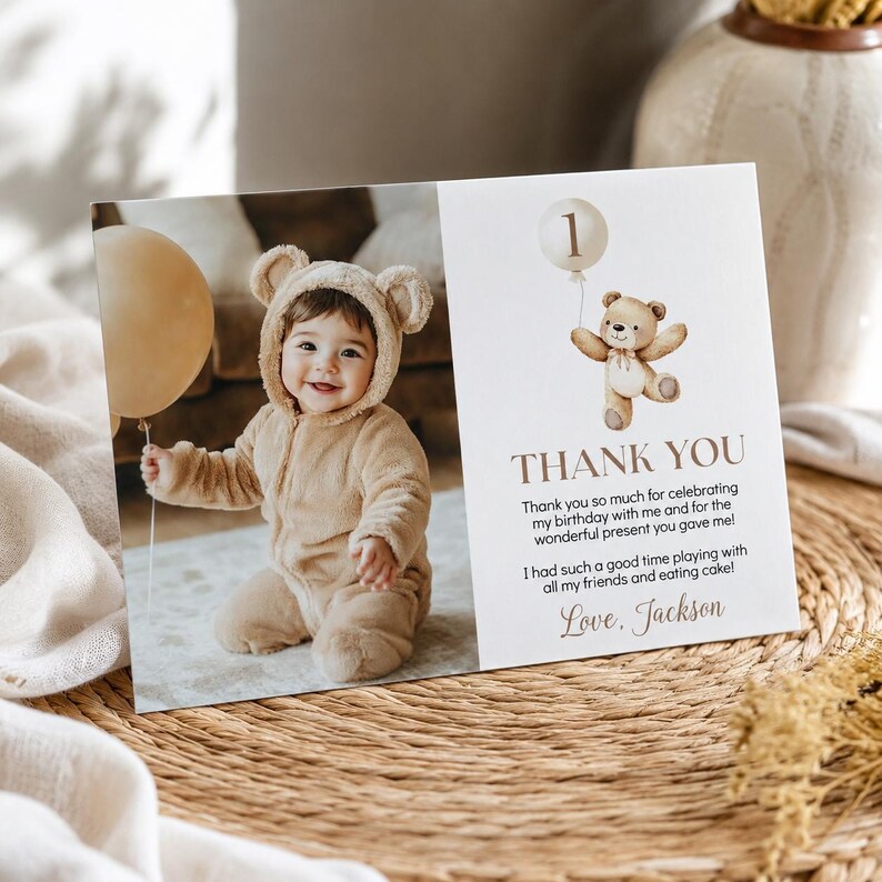 May include: A rectangular thank you card featuring a photo of a child in a tan bear-ear jumpsuit holding a beige balloon. The right side displays a watercolor teddy bear with a balloon, the text THANK YOU, and a message signed Love, Jackson.