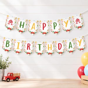 May include: A decorative banner featuring the text HAPPY BIRTHDAY in colourful letters on white pennants. Each pennant displays illustrations of farm animals, red trucks, sunflowers, and barns. The banner is strung on a white cord.