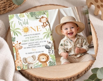 May include: A rectangular first birthday invitation card featuring a jungle theme with watercolor illustrations of a giraffe, elephant, lion, zebra, and monkey. The text reads Wild One, Jackson's First Birthday, Sunday August 10th, and Safari Garden.