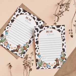 May include: Two printable cards with a cow print background and a watercolor design of cacti, cowboy boots, and a horseshoe. The cards have a space to write "Dear Oliver" and a space to write a message. The cards say "Love..." at the bottom.
