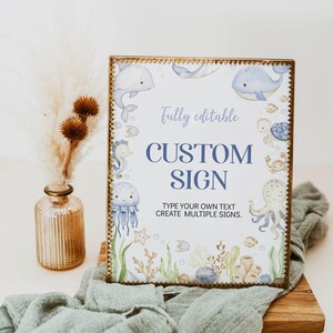 May include: A framed custom sign with a gold border, featuring a watercolor design of marine life. The sign includes the text "Fully editable" and "Custom Sign". The design includes whales, jellyfish, seahorses, and other sea creatures.