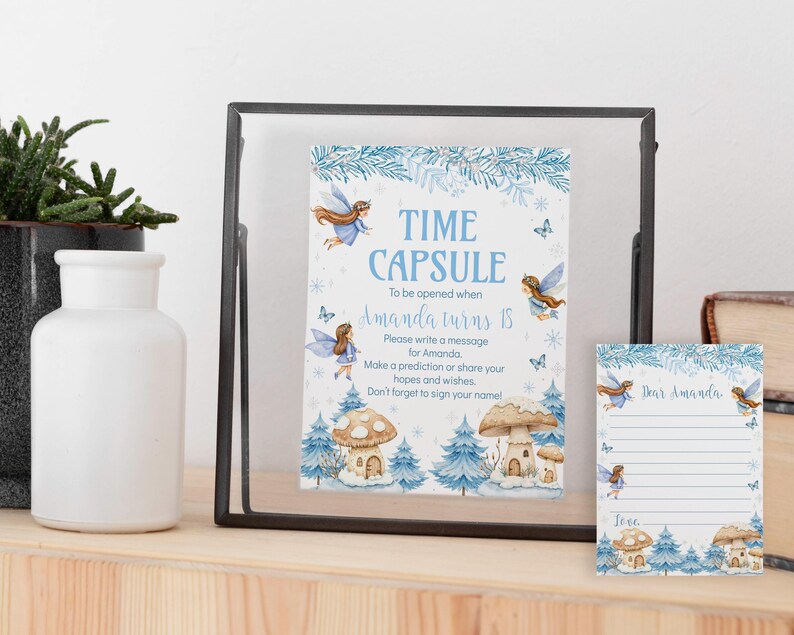 May include: A time capsule sign and matching card featuring blue fairy illustrations, mushroom houses, and pine trees. The sign reads: Time Capsule, To be opened when Amanda turns 18. Please write a message for Amanda. Make a prediction or share your hopes and wishes. Don't forget to sign your name!