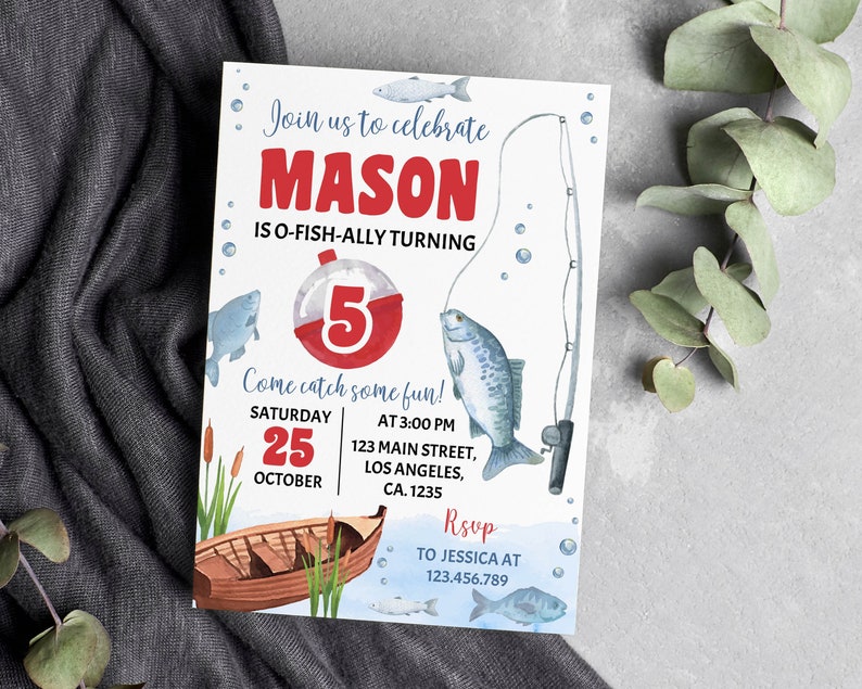 May include: A blue and white fishing-themed birthday invitation for a boy turning five. The invitation features a red and white fishing bobber with the number 5, a blue and white fish, and a fishing rod. The text on the invitation reads "Join us to celebrate Mason is O-Fish-Ally Turning 5. Come catch some fun! Saturday, October 25 at 3:00 PM, 123 Main Street, Los Angeles, CA 1235. RSVP to Jessica at 123.456.789."