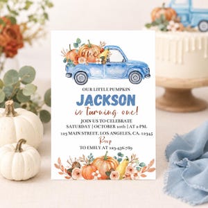 May include: A rectangular birthday invitation card featuring a watercolor illustration of a blue pickup truck carrying pumpkins. The text reads: OUR LITTLE PUMPKIN JACKSON is turning one! JOIN US TO CELEBRATE SATURDAY | OCTOBER 10th | AT 2 PM. 123 MAIN STREET, LOS ANGELES, CA. 12345 RSVP TO EMILY AT 123-456.789.