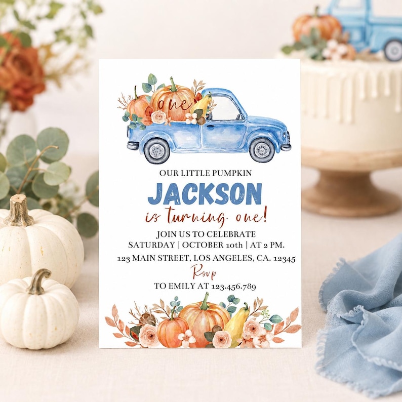May include: A rectangular birthday invitation card featuring a watercolor illustration of a blue pickup truck carrying pumpkins. The text reads: OUR LITTLE PUMPKIN JACKSON is turning one! JOIN US TO CELEBRATE SATURDAY | OCTOBER 10th | AT 2 PM. 123 MAIN STREET, LOS ANGELES, CA. 12345 RSVP TO EMILY AT 123-456.789.