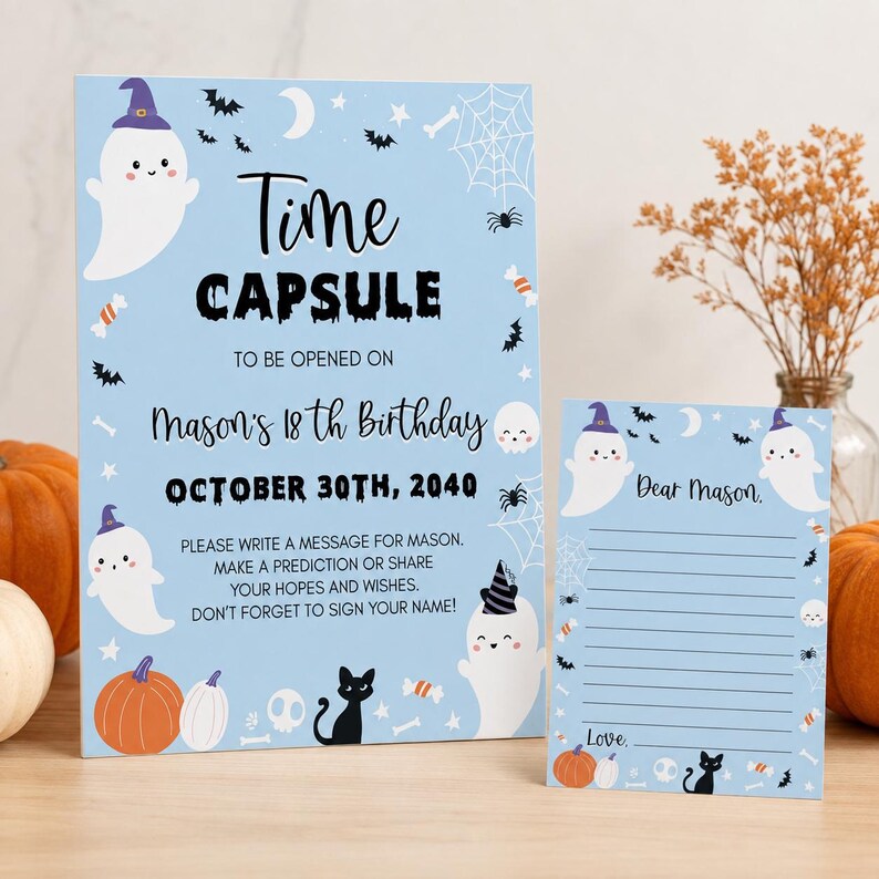 May include: A light blue time capsule sign and matching card featuring white ghosts in purple hats, black cats, orange pumpkins, spider webs, and bats. The text reads Time Capsule to be opened on Mason's 18th Birthday October 30th, 2040.