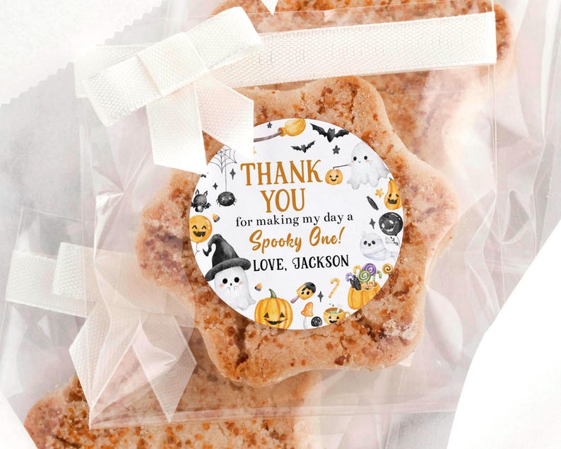 May include: A star-shaped cookie in a clear cellophane bag, tied with a white ribbon. A round sticker on the bag reads "THANK YOU for making my day a Spooky One! LOVE, JACKSON" with Halloween-themed illustrations.