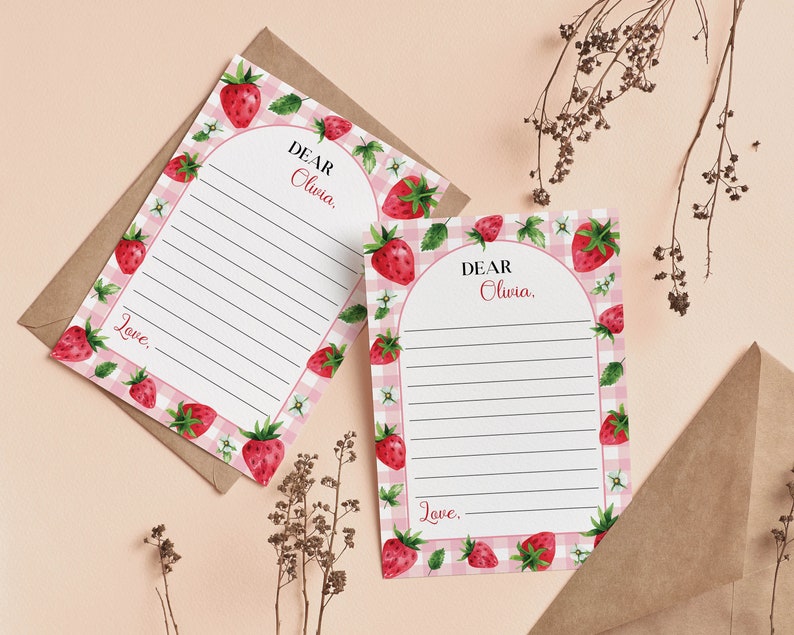 May include: Two rectangular stationery sheets featuring a pink and white gingham border decorated with watercolor strawberries, green leaves, and small white flowers. Each sheet has an arched white center with black lines and the text Dear Olivia.