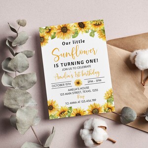 May include: A rectangular birthday invitation card featuring watercolor sunflower illustrations at the top and bottom. The text reads: Our little Sunflower IS TURNING ONE! JOIN US TO CELEBRATE Amelia's 1st birthday OCTOBER 15TH 2PM - 5PM AMELIA'S HOUSE 123 MAIN STREET, TEXAS. 1235 RSVP TO ANNA AT 123.456.789.