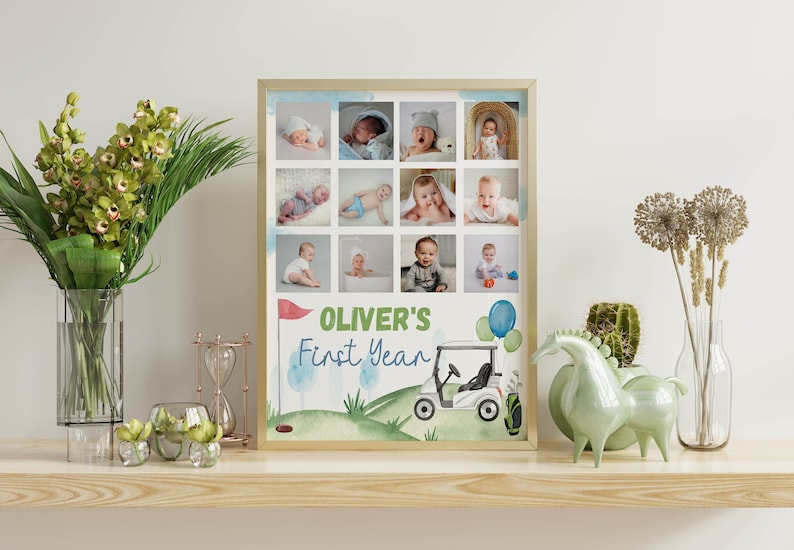 May include: A framed collage of photos of a baby boy, with a golf cart and balloons on a green background. The text "Oliver's First Year" is written in green and blue letters.