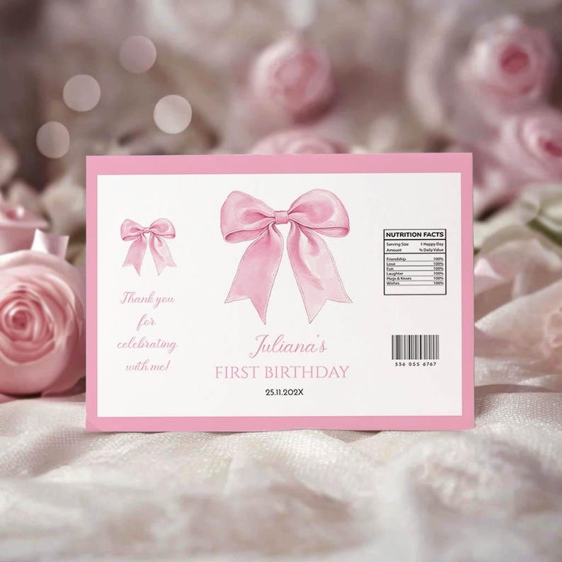 May include: A rectangular pink and white birthday label featuring a large pink bow in the center, a smaller bow on the left, and text reading Juliana's FIRST BIRTHDAY 25.11.202X. It includes a nutrition facts box, a barcode, and thank you text.