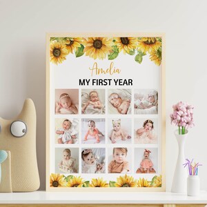 Może przedstawiać: Oprawiony kolaż zdjęć zatytułowany "Amelia MY FIRST YEAR" z dwunastoma zdjęciami dziecka. Rama jest ozdobiona akwarelowymi słonecznikami. Zdjęcia są ułożone w siatkę, prezentując pierwszy rok życia dziecka.