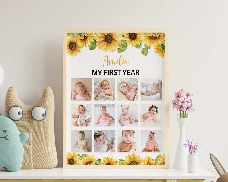 Może przedstawiać: Oprawiony kolaż zdjęć zatytułowany "Amelia MY FIRST YEAR" z dwunastoma zdjęciami dziecka. Rama jest ozdobiona akwarelowymi słonecznikami. Zdjęcia są ułożone w siatkę, prezentując pierwszy rok życia dziecka.