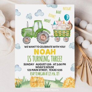 May include: A birthday invitation card featuring a green tractor pulling a wagon with farm animals wearing party hats. Text reads: WE WANT TO CELEBRATE WITH YOU! NOAH IS TURNING THREE! SUNDAY AUGUST 12th AT 2:00 PM NOAH'S HOUSE 123 MAIN STREET TEXAS 1235 RSVP TO MEGAN AT 123.456.789.