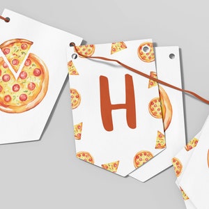 May include: A white banner with a pizza pattern and the letter "H" in orange. The banner is strung with brown twine and has holes for hanging.