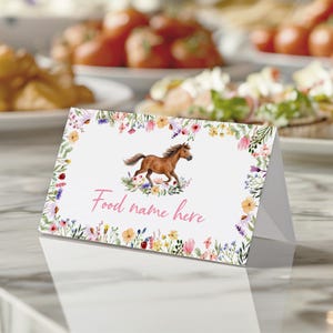 May include: A folded white card with a watercolor illustration of a brown horse running through a field of flowers. The card is framed by a floral border and has the text "Food name here" in pink.