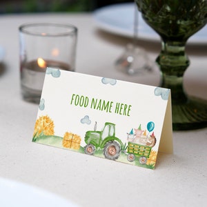 May include: A green tractor with a bale of hay in the back, pulling a wagon with farm animals wearing party hats. The text "FOOD NAME HERE" is printed on the card.