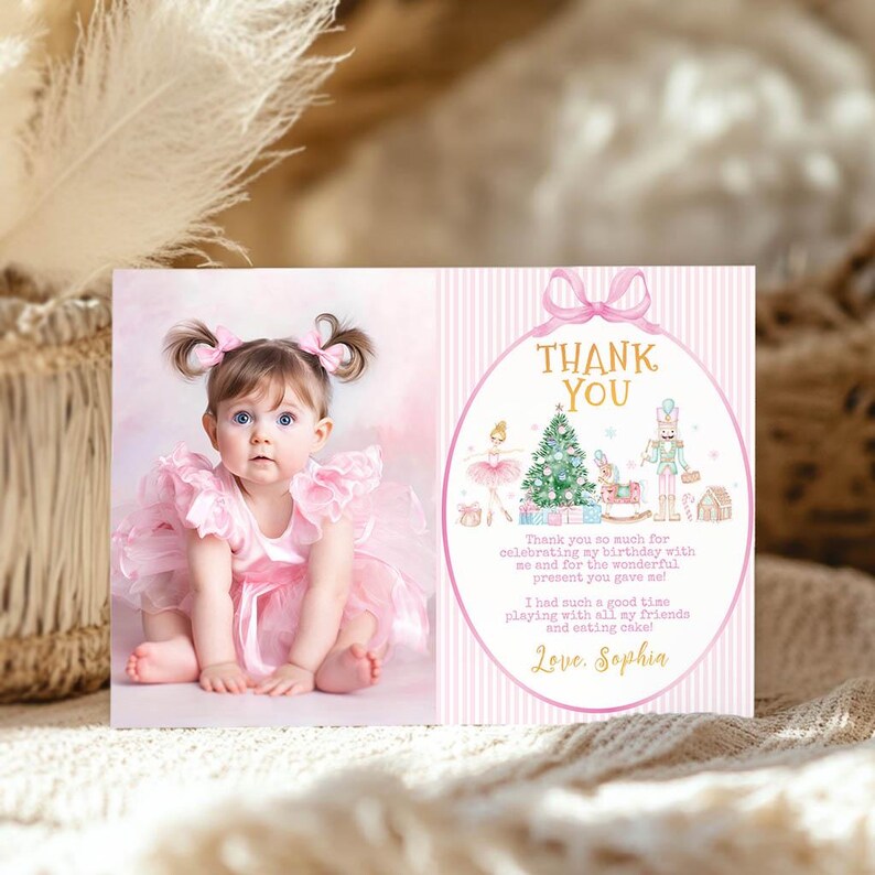 May include: A rectangular thank you card featuring a photograph of a toddler in a pink ruffled dress on the left and a pink striped background with a nutcracker, ballerina, and Christmas tree illustration on the right with the text Thank You.