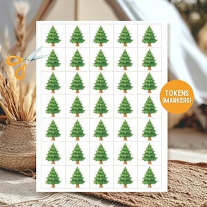 May include: A sheet of paper with 30 green Christmas tree tokens, labeled "TOKENS (MARKERS)". A pair of scissors is placed next to the paper. The tokens are arranged in a grid pattern.