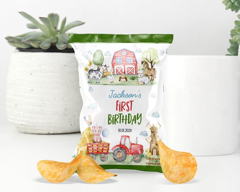 May include: A custom snack bag featuring a watercolor farm theme with a red barn, tractor, and various animals. The text reads Jackson's FIRST BIRTHDAY 10.01.202X. The bag is decorated with green borders and is displayed with three potato chips in the foreground.