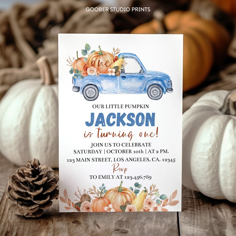 May include: A rectangular invitation card featuring a watercolor illustration of a blue pickup truck carrying pumpkins and flowers. The text reads: GOOBER STUDIO PRINTS, OUR LITTLE PUMPKIN JACKSON is turning one! JOIN US TO CELEBRATE SATURDAY | OCTOBER 10th | AT 2 PM. 123 MAIN STREET, LOS ANGELES, CA. 12345 RSVP TO EMILY AT 123.456.789.