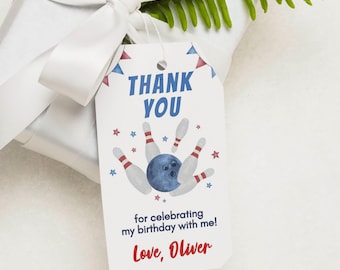 May include: A white gift tag with a bowling theme. The tag reads "THANK YOU" in blue, with a bowling ball and pins graphic. The text "for celebrating my birthday with me! Love, Oliver" is also included. The tag is attached to a wrapped gift with a white bow.