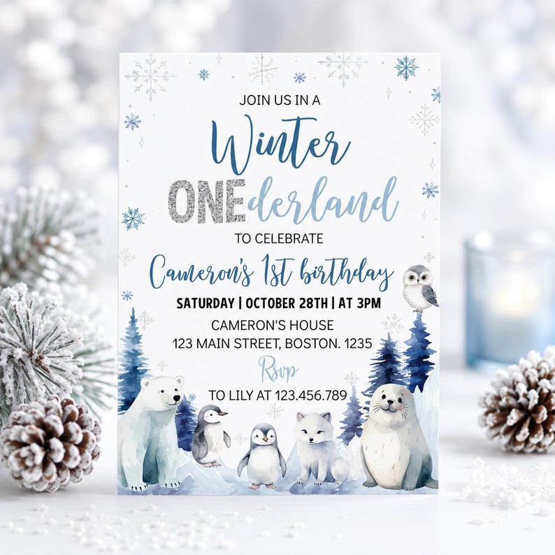 May include: A rectangular invitation card featuring the text JOIN US IN A Winter ONEderland TO CELEBRATE Cameron's 1st birthday. The design includes blue and silver snowflakes, watercolor illustrations of a polar bear, penguins, a fox, and a seal.