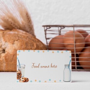 May include: A white card with blue and orange polka dots. The card has a picture of a glass of milk with a straw, cookies, and a bottle of milk. The text on the card reads "Food name here".