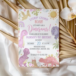 May include: A rectangular birthday invitation card featuring watercolor illustrations of dinosaurs, a volcano, sun, and flowers. Text reads: STOMP! CHOMP! ROAR! LET'S PARTY LIKE A DINOSAUR! PLEASE JOIN US TO CELEBRATE MADISON'S 1ST BIRTHDAY SATURDAY DECEMBER 20 AT 2:00 PM.