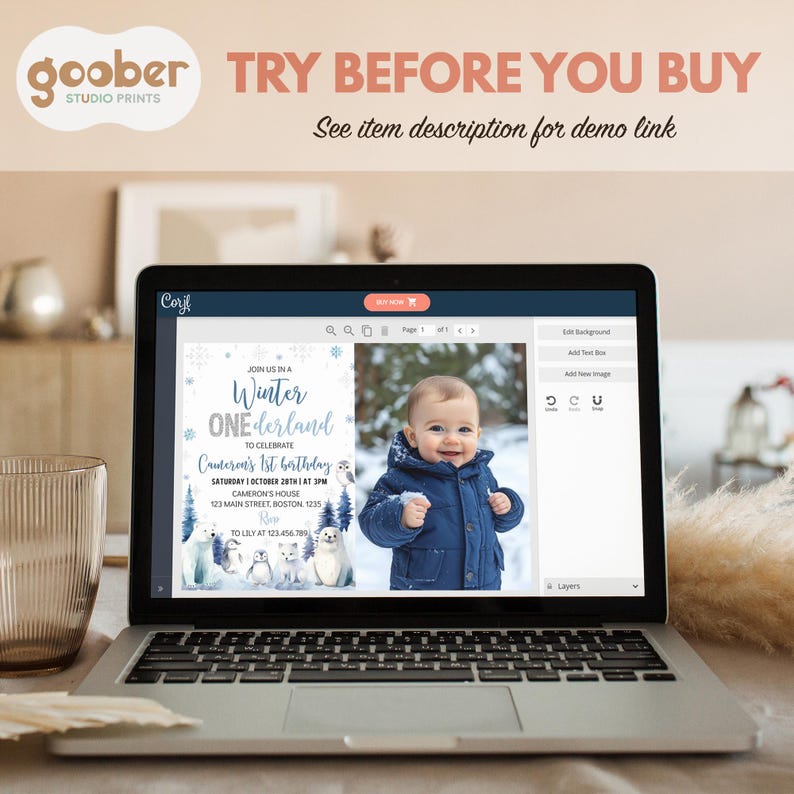 May include: A laptop screen displaying a customizable digital invitation template for a Winter ONEderland first birthday party, featuring blue text, snowflake graphics, and arctic animals alongside a photo of a child in a blue winter coat.