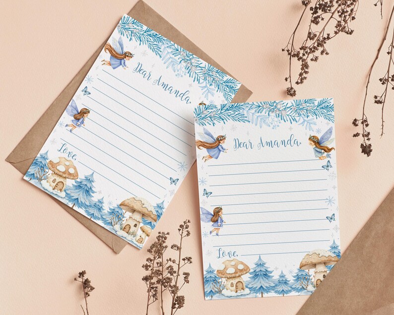 May include: Two sheets of lined stationery featuring a blue winter forest theme with illustrations of fairies, butterflies, and mushroom houses. The top of each page includes the printed text Dear Amanda and the bottom includes the printed text Love.