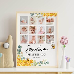 May include: A rectangular framed print featuring a twelve-photo collage of a baby, numbered one through twelve. The design includes watercolor illustrations of honeycombs, bees, and flowers. Text reads: Sophia, FIRST BEE - DAY, 22.09.202X.