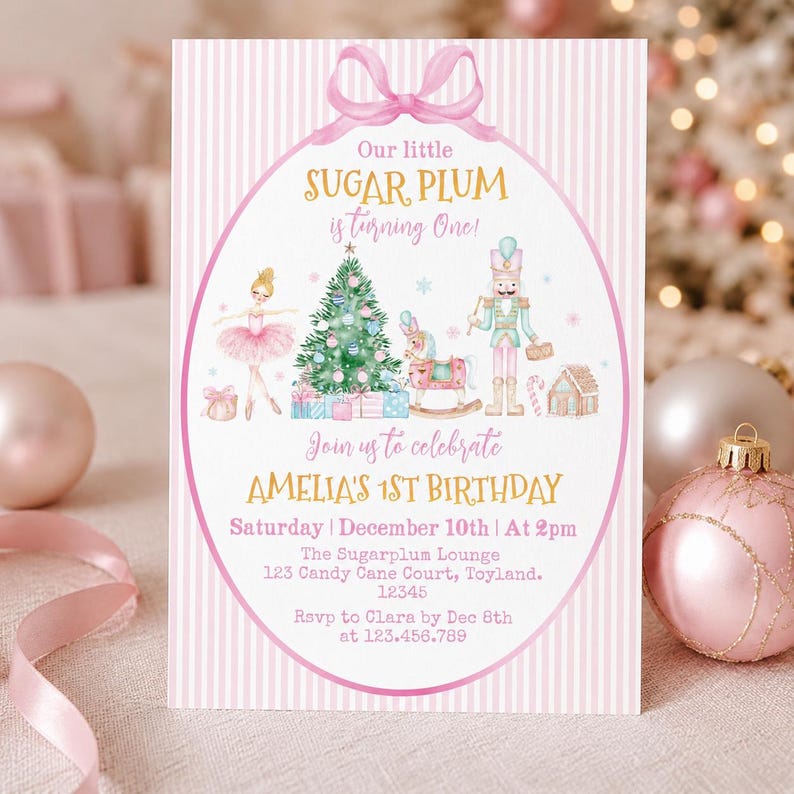 May include: A rectangular birthday invitation card with a pink and white striped background. It features a central oval frame with a pink bow, displaying a ballerina, a Christmas tree, a rocking horse, a nutcracker, and text for Amelia's 1st birthday.