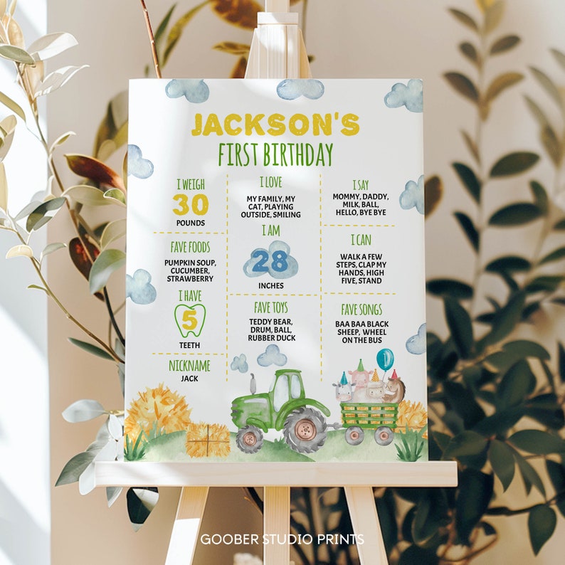 May include: A white birthday milestone sign for Jackson featuring yellow and green text, blue clouds, and a green tractor pulling a wagon with farm animals. The board lists personal details including 30 pounds, 28 inches, and 5 teeth.