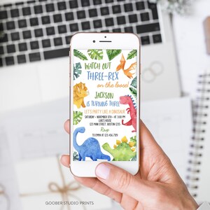 May include: A digital invitation for a dinosaur-themed birthday party. The invitation features a colorful illustration of dinosaurs and the text "Watch Out Three-Rex on the loose! Jackson is turning three. Let's party like a dinosaur. Saturday, November 11th at 3:00 PM. Luke's House, 123 Main Street, Boston 1235. RSVP to Emma at 123.456.789."