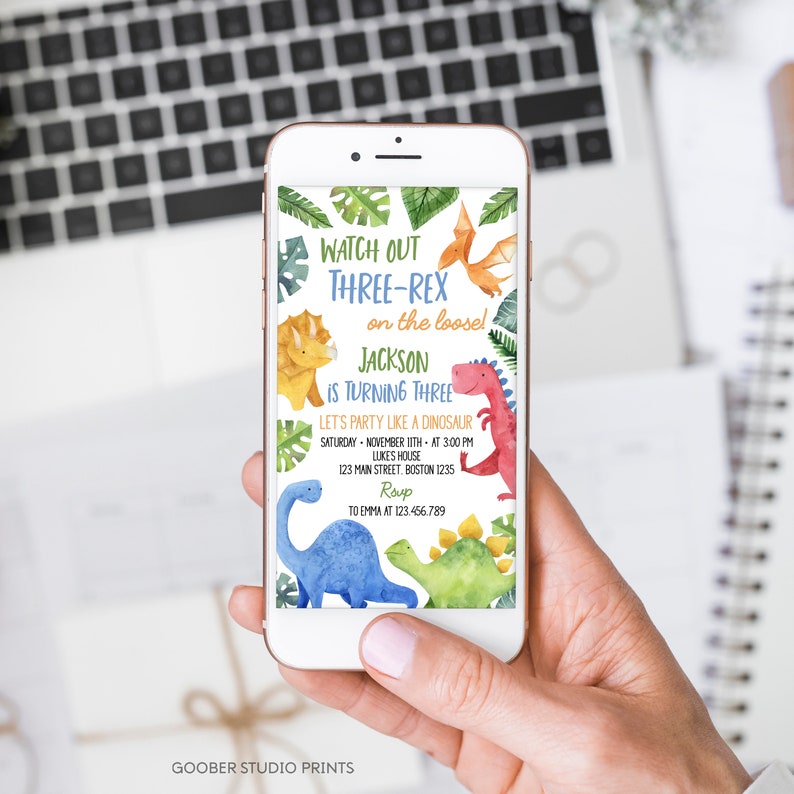 May include: A digital invitation for a dinosaur-themed birthday party. The invitation features a colorful illustration of dinosaurs and the text "Watch Out Three-Rex on the loose! Jackson is turning three. Let's party like a dinosaur. Saturday, November 11th at 3:00 PM. Luke's House, 123 Main Street, Boston 1235. RSVP to Emma at 123.456.789."