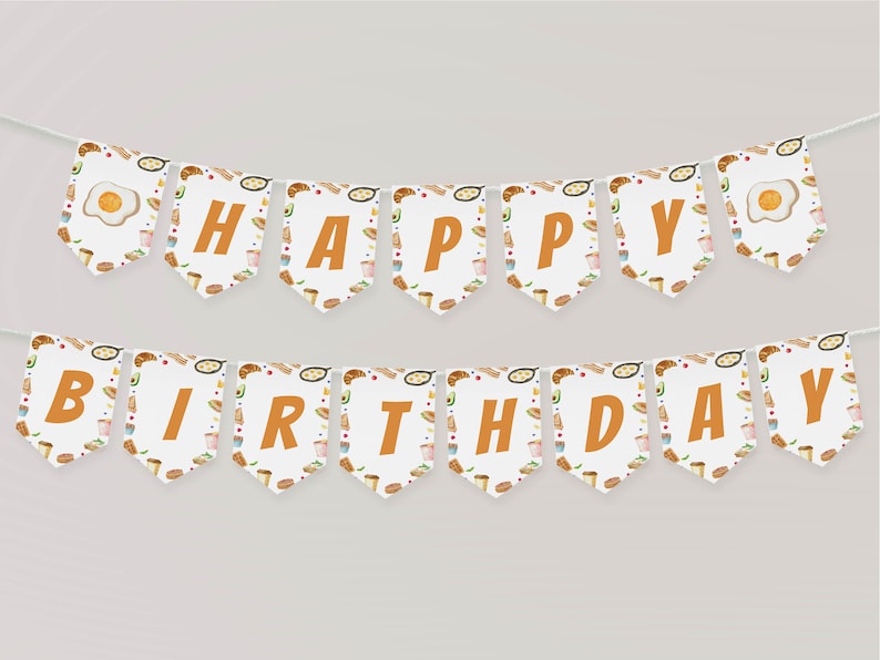 May include: A white and orange banner with the words "Happy Birthday" in orange letters. The banner is decorated with a breakfast food theme, including eggs, bacon, toast, and coffee.
