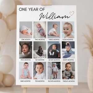 May include: A white rectangular milestone poster titled ONE YEAR OF William with a heart icon. It features twelve square photographs of a baby, each labelled with a month from one to twelve, documenting growth from infancy to one year of age.