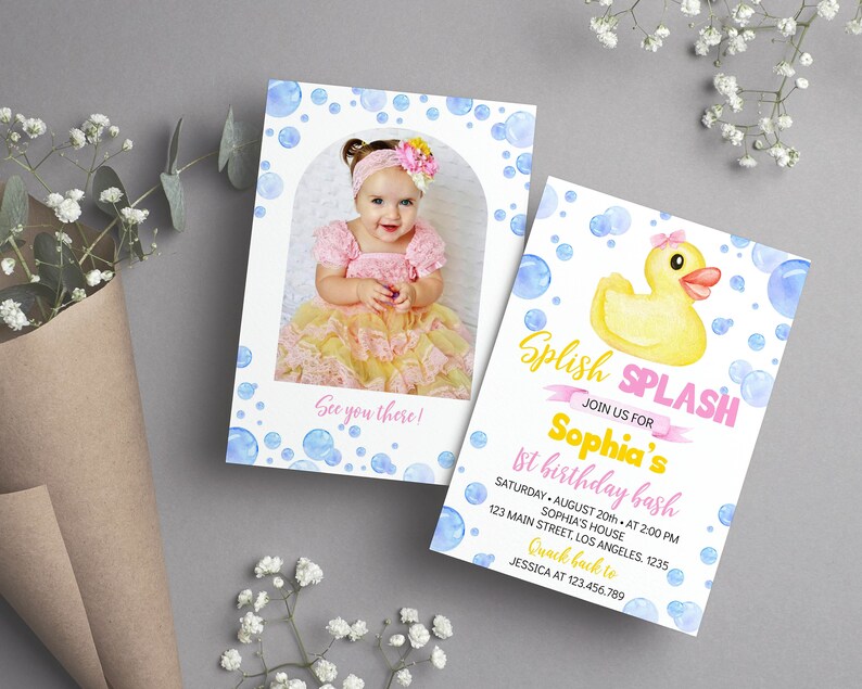 May include: Two rectangular birthday invitation cards featuring a watercolor blue bubble pattern. One card displays a photo of a child in a pink and yellow dress, the other features a yellow rubber duck and text: Splish Splash Join us for Sophia's 1st birthday bash, Saturday August 20th at 2:00 PM, Sophia's house, 123 Main Street, Los Angeles, 1235, Quack back to Jessica at 123.456.789.