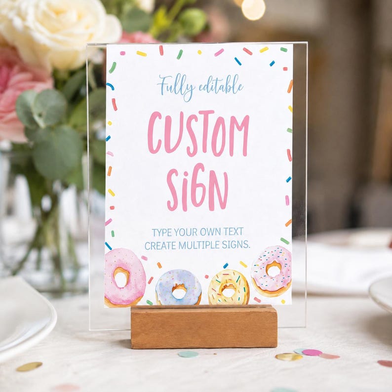 K&ouml;nnte beinhalten: Ein rechteckiges Acrylschild in einem Holzsockel mit wei&szlig;em Hintergrund, bunten Streuseln, dem rosa Text CUSTOM SIGN, dem blauen Text Fully editable und TYPE YOUR OWN TEXT CREATE MULTIPLE SIGNS sowie vier Aquarell-Donuts.