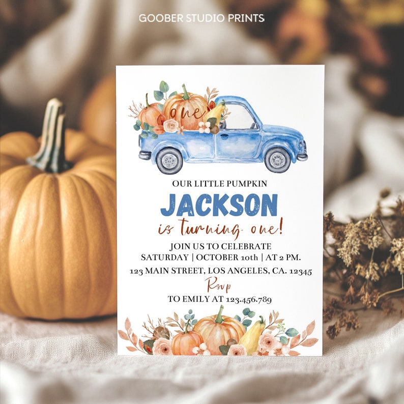 May include: A rectangular birthday invitation card featuring a watercolor illustration of a blue pickup truck carrying pumpkins and flowers. The text reads: GOOBER STUDIO PRINTS, OUR LITTLE PUMPKIN JACKSON is turning one! JOIN US TO CELEBRATE SATURDAY | OCTOBER 10th | AT 2 PM. 123 MAIN STREET, LOS ANGELES, CA. 12345 RSVP TO EMILY AT 123.456.789.